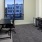 a room with a desk and chairs