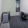 an empty office with a desk and chairs
