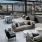 a large modern looking patio with a large glass wall and a patio with a large glass wall and